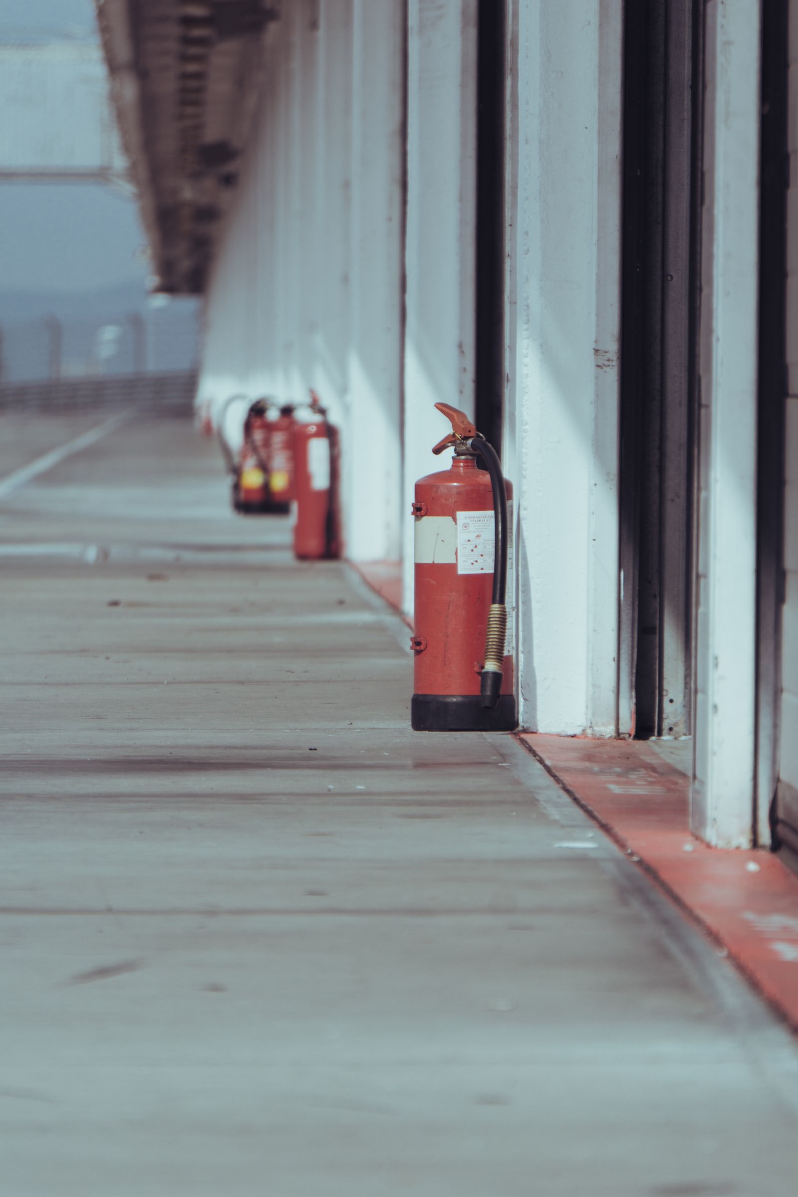Fire extinguishers positioned along a commercial corridor